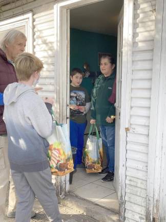 Warwick Area Farmworker Organization volunteers deliver packages to farmworker families for the holidays.