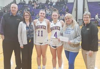 Warwick Girls Basketball Coach Jim O’Brien (l-r), WVHS Principal Marguerite Fusco, team captains Paige Girardi and Megan Desrats, American Cancer Society representative Kristi Greco, and Athletic Trainer Sue Abel during a recent $4000 donation presentation to the American Cancer Society.