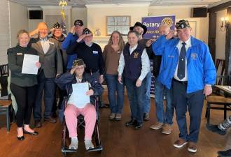 Jennifer DeFrancesco, executive director of Hudson Valley Honor Flight with (standing l-r) veterans Ed Lynch, Mike Eckert, Tom Brennan, Tony Cosimano, Warwick Rotary president Laura Barca, Candido Rivera, John McDonald, Everist Lemay and Stan Martin. Rose Becker is seated in front.
