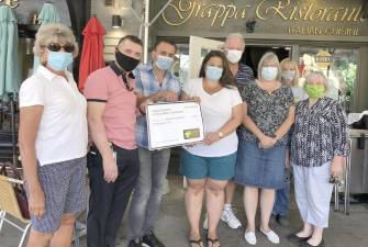 Grappa Ristorante and La Piazza Martini and Wine Bar owners donated $5,000 to Backpack Snack Attack. From left, Backpack volunteer Lynne Nilsestuen, Nick Ahmetaj, Tony Sylaj, Backpack Director Jenna Price, and volunteers Len Singer, Mary Schweitzer, Monica Dorfman and Paulette Rudy. Provided photo.