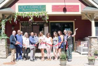 On Thursday, Sept. 2, Town of Warwick Supervisor Michael Sweeton (left) and members of the Warwick Valley Chamber of Commerce joined founder and designer Adriana Lobosco (center), her family and friends to celebrate the Lilly and Grace newly opened boutique in the rear of the Meadowcrest Plaza building at 127 Route 94 S. in Warwick. Photo by Roger Gavan.