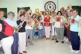 Warwick Valley Quilters’ Guild members display the Applefest quilt blocks they made from Louise LoPinto Hutchison's design in 2008. Photos provided by Pattie Whelan.