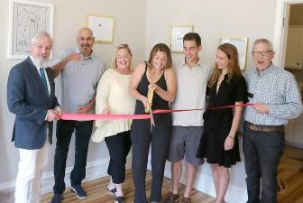 On Friday, July 30, Mayor Michael Newhard (left), Warwick Valley Chamber of Commerce Executive Director Michael Johndrow (right) and Chamber members joined founder Katy Melendez (center), her family and friends to celebrate the opening of her new studio at 24 Main St. with a ribbon-cutting ceremony. Photo by Roger Gavan.