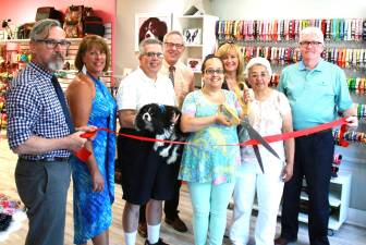 Photo by Bea Arner On July 27, village officials and chamber representatives joined Diva Dog Pet Boutique &amp; Barkery owner Francesca Pou and her family to celebrate the store's grand opening at its new location. From left, Mayor Michael Newhard, Warwick Valley Chamber of Commerce President Mechelle Casciotta, Hector Pou holding &quot;Minnie,&quot; Chamber Executive Director Michael Johndrow, owner Francesca Pou, Chamber Board member Caryn Burke, Maria Pou and Village of Warwick Deputy Mayor and Orange County Legislator Barry Cheney.