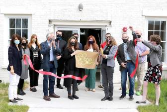 On Tuesday, April 27, Town of Warwick Supervisor Michael Sweeton, Mayor Michael Newhard and members of the Warwick Valley Chamber of Commerce joined owners Cindy Allyn and Tanja Lewit (center) along with their business neighbors and associates to celebrate the firm’s grand opening in the Manor House at 255 State School Road. Photo by Roger Gavan.