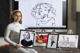 Warwick Valley High School student Arianna Foutch-Mann with some of her art on Jan. 19, 2022. The image on the screen in the background is from her animated film.