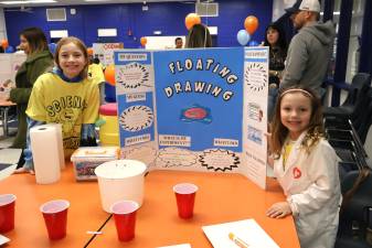 Sisters Lena and Zoe Radon show off their project at the Golden Hill Science Symposium.