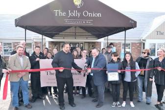 On Saturday, Nov. 9, local officials and members of the Pine Island Chamber of Commerce joined owners Chef Armand Vanderstigchel and Thomas Mastrantoni (center) along with members of their staff and associates to celebrate the restaurant’s first anniversary with a ribbon-cutting ceremony.