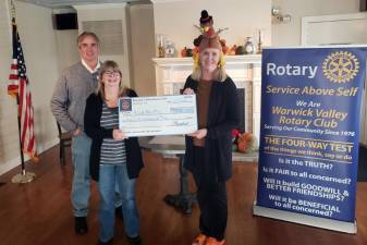 Volunteers Beth Maas and Pat Nolan accepted $1,500 checks on behalf of the Florida and Greenwood Lake Food Pantries to assist with increased holiday demand and rising food prices. Leo R. Kaytes, president of the Warwick Valley Rotary Club, presented the $3,000 in donations at the service club’s Nov. 17 meeting at the Landmark Inn. The Warwick Food Pantry received its donation in a separate presentation. Photo by Jim LaPlante.