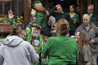 There was a good crowd outside Yesterdays Irish Pub with owner John Christison waving and recording the activity outside while wearing his green three leaf clover suit during the St. Patrick’s Day Parade on March 17, in the Village of Warwick