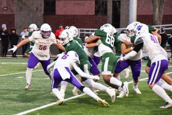 Warwick’s Nick Sirico (#6), Grant Havell (#56) and Wyatt Vreeland (#41) converge on Cornwall’s running back in the Section IX Class A Semifinal. Cornwall defeated the Wildcats and will move on to the championship this weekend.