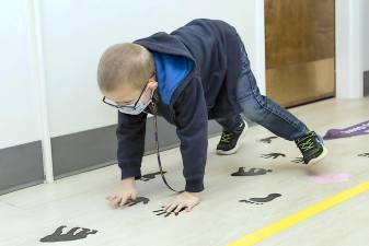 Kindergarteners use the new sensory path at Pine Island Elementary Schoo1. Among the activities is to walk like a gorilla by following handprints and footprints. Photos by Tom Bushey/WVSD.