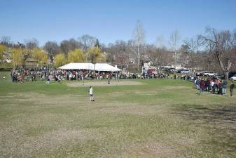 People eager to shop for free line up outside the basketball court, Stanley Deming Park