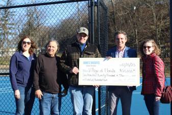 State Sen. James Skoufis presents a check to village officials for the courts.