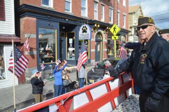 Local residents wave to the VFW veterans as they pass by on their float.