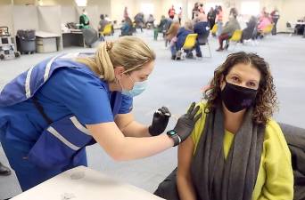 Kaitlin Concannon, 24, a volunteer nurse from Monroe, administers a shot of the Moderna COVID-19 vaccine to Jennifer Ahearn of New Hampton, a teacher at Monroe-Woodbury Middle School. Provided photos.