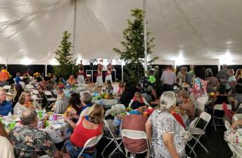 Almost 200 persons attended last year’s End of Summer Luau Party at Wickham Woodlands. Warwick Rotarians have ordered a larger tent - 120-feet by 40 feet - will allow for 250 guests this year.