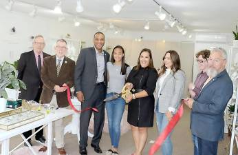 On Friday, Oct. 4, Town of Warwick Supervisor Michael Sweeton (second from left), Mayor Michael Newhard (far right) and members of the Warwick Valley Chamber of Commerce joined Kally Padilla (center), her husband Rey, daughter Daniella and staff member Laura Catli to celebrate the shop’s first anniversary with a ribbon cutting.