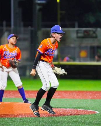 Pitcher Tom McKeon is pumped up after striking out the final batter against Port Washington as CJ Davila looks on.