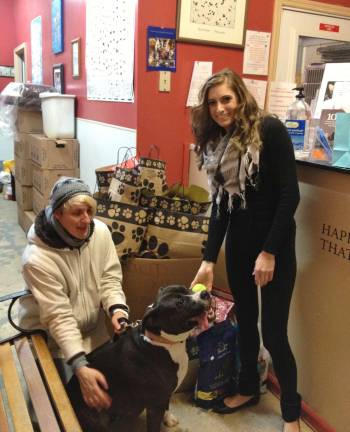 Kayla Scarane, right, owner of Scarlet's Way with Goshen Humane Society volunteer Vaia Mcginnity and Trixie, a sweet and playful 2 to 3-year-old mix breed who is available for adoption.