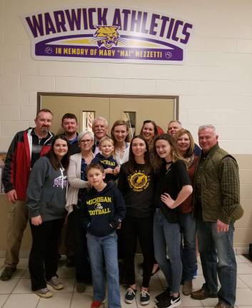 Photo provided by the Warwick Valley Athletic Department Myles Vincent Mezzetti and the Mezzetti Family are pictured with the entrance sign to the Warwick Valley High School gymnasium donated in Mary &#x201c;Mai&#x201d; Mezzetti&#x2019;s name.