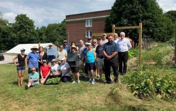 Supervisor Michael Sweeton, Legislator Paul Ruskiewicz and Village Board member and County Legislator Barry Cheney (all front right), participated in the celebration of the tenth anniversary of the Warwick Community Garden on the grounds of the Warwick Community Center.