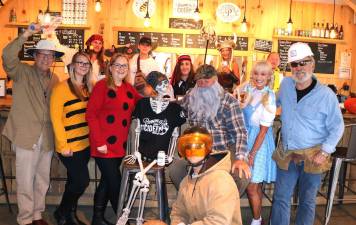 Photo by Roger Gavan From left, planning the Warwick Valley Chamber of Commerce Tuesday, Oct. 30, Halloween Mixer at the Pennings Farm Cidey bar are (rear) Pennings Farm Cidery staff Mike Stubeck, Penny Greibesland, Leonard Geraci, Sara Majewski and Matt Sampson; (front and center) co-owners S.J. and Steve Pennings. Front from left, Warwick Valley Chamber of Commerce members Executive Director Michael Johndrow, Bea Arner, Sarah Armand, Janine Dethmers and Chamber President John Redman.