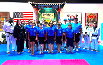 Warwick Junior Police Academy participants, along with Chosun instructors, at the Chosun Taekwondo Academy.