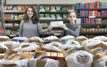 Small Things Inc. recently donated $500 to the Warwick Ecumenical Food Pantry. Pictured from left to right are Tracy Gregoire, founder of Small Things Inc., and Glenn Dickes, the director of the Warwick Ecumenical Food Pantry.