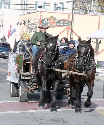 Sean Giery and his team of Percherons, Jack and Bob, were in the Village of Warwick again with their mascot “Butch,” who enjoys riding shotgun. And visitors bundled up and took advantage throughout the day of a free horse and buggy ride through the village.