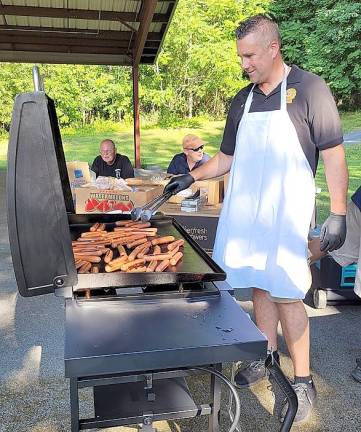Warwick Police Detective Mike Hoffman grills up some hotdogs at ‘National Night Out.’