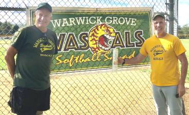 The Warwick Grove softball team players donated $600 to Backpack Snack Attack as part of Back to School Month. Pictured are Charlie Marron (right), head of Warwick Grove Softball, with Len Singer (left), Backpack volunteer.