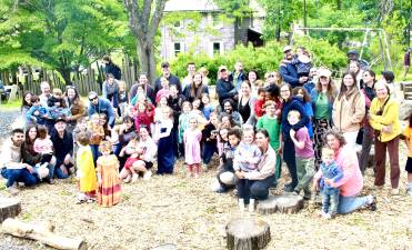 Melissa Reali, center, surrounded by the families that attend Playing Together Being Together classes.