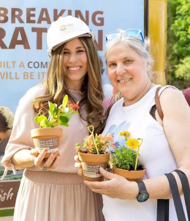 Brigitte Glasser of Chester, pictured with Chana Burston, holds her “Flowers for the Soul using Synagogue Soil” she made at the Chabad Campus Groundbreaking Celebration.