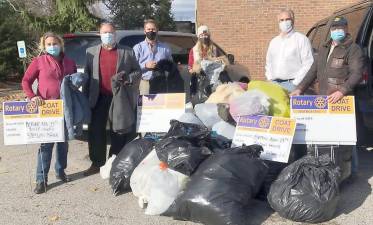 The Rotary Club of Warwick collected 200 winter coats for donation to Catholic Charities. From left to right club members are: Joyce Perron; Ed Lynch, club president; Leo Kaytes; and Neil Sinclair helped Michael Peters and Kerri Foley (center) of Catholic Charities load up the generous donation. Provided photos.