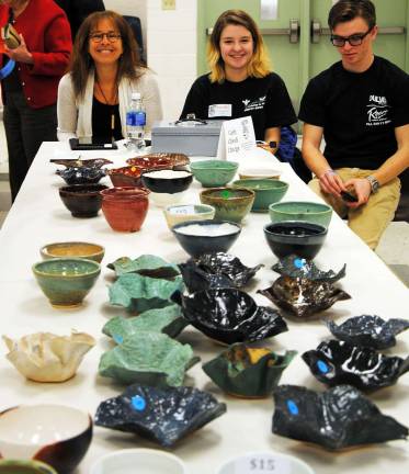Warwick potter Dr. Deb Bernstein and WVHS volunteers Barbara Schweitzer and Will Chester sell pottery bowls made and donated to Empty Bowls by local potters.