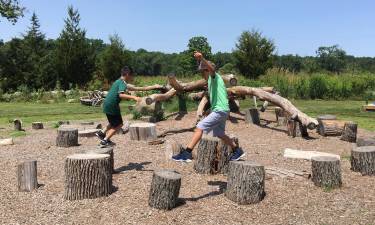 Students from the Warwick Area Migrant Committee's summer enrichment program - Dulce Esperanza - explore the outdoor activity area at the Hudson Highlands Museum in Cornwall.