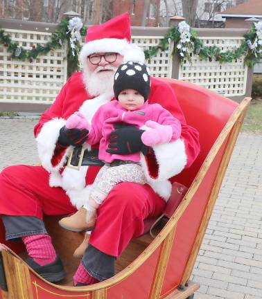 Raelynn Beysel is only 17 months old and she was happy to sit with Santa.