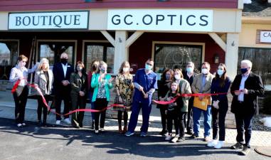 On Wednesday, March 3, members of the Warwick Valley Chamber of Commerce joined GC Optics founders Galo Andrade and Jenny Altman (center), their eight year-old daughter Luisa, staff, relatives, friends and business associates to celebrate the official grand opening of the new family owned optical with a ribbon cutting-ceremony. Photo by Roger Gavan.