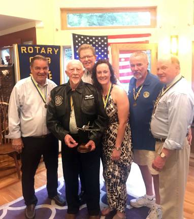 Joe Baltes, former Air Force combat pilot and lone surviving charter member of the 1976 Warwick Valley Rotary Club, proudly wears a flight jacket with a Rotary emblem presented to him during an installation ceremony tribute. Shown, left to right, with Baltes are Stan Martin, Cal Hargis, Katie Hansen, John Buckley and Ed Wiley.