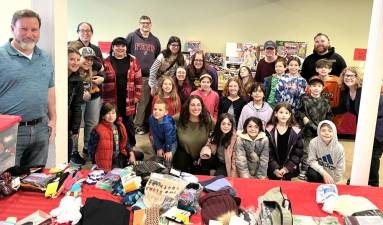 Students, parents, and teachers from Beit Sefer of Orange County helped organize gifts for the clients of Florida Food Pantry on Dec. 2. They also learned about food insecurity and the value of the local food pantry.