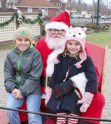 Colby Bontemps, 8, and his sister Cassidy, 5, enjoy their visit with Santa.