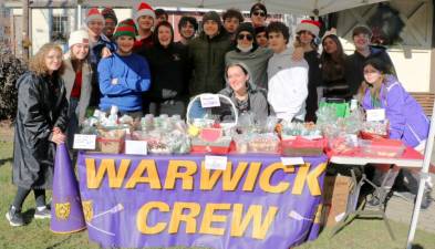 Members of the Warwick Valley High School Crew Team were stationed on Railroad Green on Sunday, Dec. 12, selling cookies and other treats to help support their sport. The team competes in races throughout the Hudson Valley and practices on Greenwood Lake. Photo by Roger Gavan.