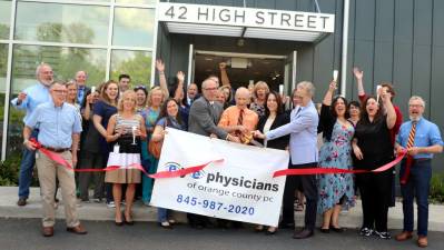 Photo by Roger Gavan On Friday, June 8, Town of Warwick Supervisor Michael Sweeton (far left), Mayor Michael Newhard (far right) and members of the Warwick Valley Chamber of Commerce joined Doctors Mark Stamm, Leslie Green, Mandes Kates and Yochanan Burnstein, partners (center) of Eye Physicians of Orange County PC, their staff and friends to celebrate their new office at 42 High St., in the Village of Warwick.