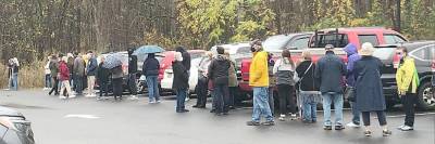 Voters wait in line in the parking lot at Warwick Town Hall to take advantage of early voting on Monday. Photos by Linda Smith Hancharick