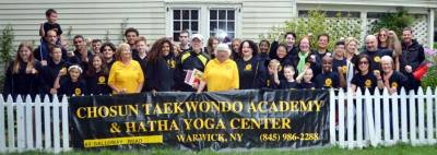 The Chosun Taekwondo Academy Leadership Team with Warwick Mayor Michael Newhard, Warwick Town Supervisor Michael Sweeton, and members of the Warwick Lions Club and Warwick Valley Rotary Club. The academy’s 13th annual book sale to be held Sept. 10 in Lewis Park on Main Street in Warwick. Provided photo.