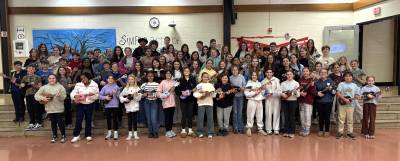 WVMS Ukulele Club students pose with their instruments.