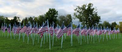 File photo by Roger Gavan. A sea of flags flying proudly with plaques identifying each hero.