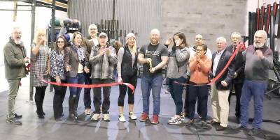 On Friday, Jan. 10, Mayor Michael Newhard (far left) and members of the Warwick Valley Chamber of Commerce joined owner Ryan Hansen (center), his staff, clients and other supporters to celebrate the anniversary and new location of Intrepid Strength &amp; Conditioning Crossfit-Warwick with a ribbon cutting.