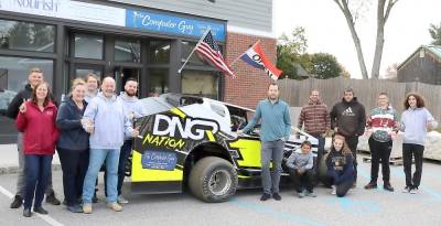 On Saturday, Oct. 26, at 7 p.m. The Computer Guy, which offers an array of computer services for residents and businesses in Warwick, Goshen and Florida, will sponsor a race car in the featured Eastern States Small Block Modified Championship 100 laps race. Posing with family and staff with the small block modifed DNGR Nation race car are Computer Guy Kevin Brand (left) and race car driver Johnny Illanovsky (center of car).